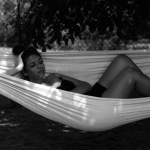 beautiful girl from South Africa on the hammock in the garden Of Eridu guesthouse in toscany