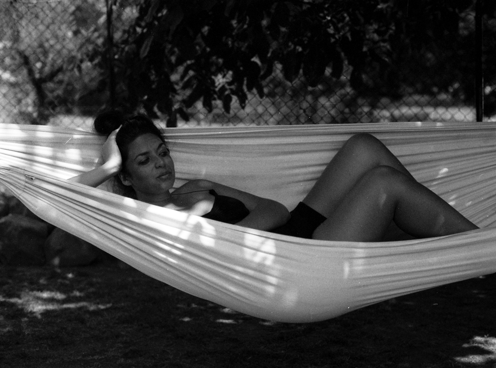 beautiful girl from South Africa on the hammock in the garden Of Eridu guesthouse in toscany